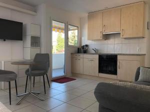 a kitchen with a table and chairs in a room at Apartment Studio Rubi Weggis by Interhome in Weggis