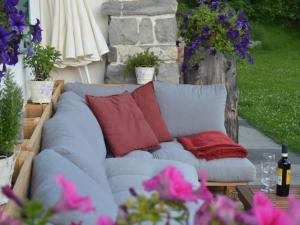 a blue couch with red pillows on a patio at Apartment be und mee by Interhome in Rigi Kaltbad