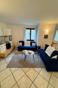 a living room with a blue couch and a table at Apartment Walserwohnung by Interhome in Bosco Gurin