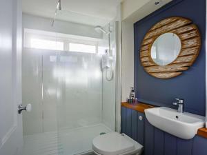 a bathroom with a toilet and a sink and a mirror at 2 Bed in Berwick-upon-tweed oc-82189 in Spittal +9 photos