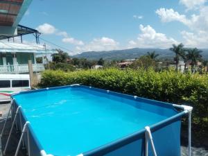a blue swimming pool with mountains in the background at Hospedaje Villa Laura in Cite
