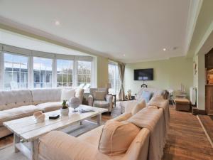 a large living room with couches and a table at 6 Bed in Rye- oc-89037 in Camber