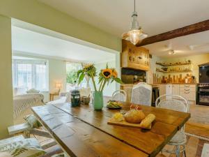 a living room with a wooden table and a kitchen at 6 Bed in Rye- oc-89037 in Camber
