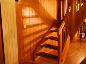 a staircase in a room with a wooden wall at Apartment Karotte by Interhome in Trub
