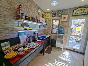 a restaurant with a counter with food on it at Hosteria Marina Bella 3 in Rada Tilly