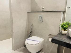 a bathroom with a white toilet and a sink at Legacy Dreams in Islamabad