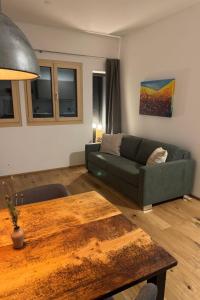 a living room with a couch and a table at Apartment Poste viglia by Interhome in Lohn +7 photos