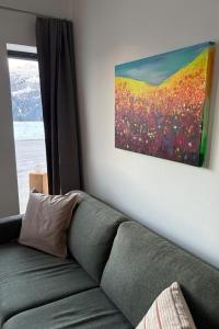 a couch in a living room with a painting on the wall at Apartment Poste viglia by Interhome in Lohn