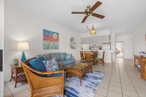 a living room with a couch and a table at Grand Champions 033 in Wailea