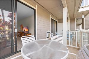 a room with a white table and chairs on a balcony at Grand Champions 033 in Wailea +28 photos