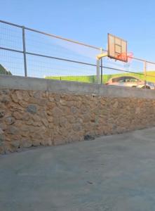 a stone retaining wall with a basketball hoop at New view in Majdal Shams