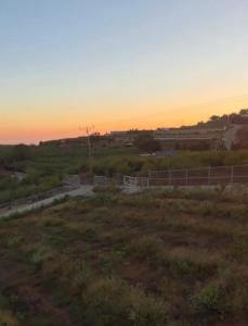 a road in a field with the sunset in the background at New view in Majdal Shams