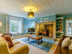 a living room with a couch and a fireplace at 4 Bed in Hexham oc-90521 in Bardon Mill