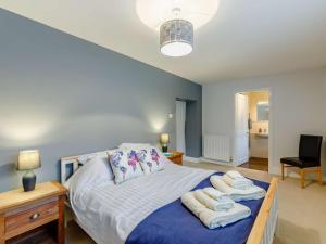 a bedroom with a bed with towels on it at 4 Bed in Hexham oc-90521 in Bardon Mill
