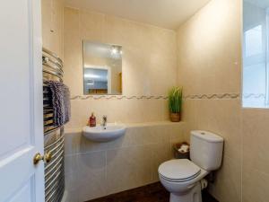 a bathroom with a toilet and a sink at 4 Bed in Hexham oc-90521 in Bardon Mill +17 photos