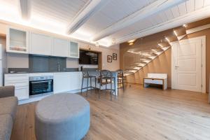 a kitchen and living room with a spiral staircase at La Vecchia cantina Guzzardi in Lari