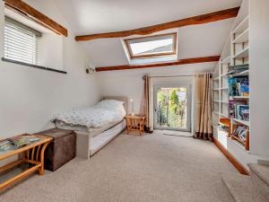 a bedroom with a bed and a book shelf at 3 Bed in Keswick oc-94346 in Threlkeld
