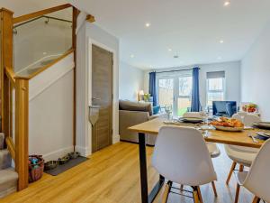 a living room with a dining room table and chairs at 2 Bed in Sandown oc-89291 in Sandown +10 photos