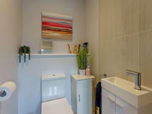 a bathroom with a white toilet and a sink at 2 Bed in Sandown oc-89291 in Sandown