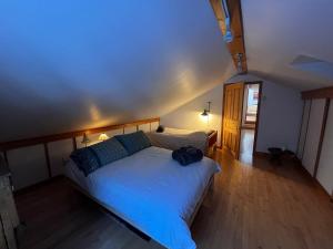 a bedroom with a large bed with a blue blanket at Le Domek de nature apaisante in Sainte Béatrix