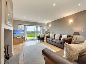 a living room with a couch and a tv at 3 Bed in Beadnell oc-cn113 in Beadnell