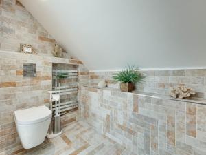 a bathroom with a toilet and a sink at 3 Bed in Beadnell oc-cn113 in Beadnell +12 photos