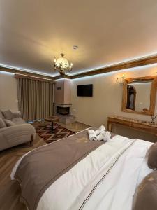 a large bedroom with a large bed and a mirror at Hotel Restorant Unaza in Voskopojë