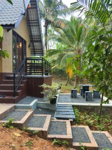 a house with steps leading up to a building at Sansun Villa in Harumalgoda West +2 photos
