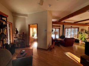 a living room with a couch and a table at Le Domek de nature apaisante in Sainte Béatrix
