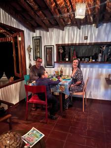 a group of people sitting at a table in a restaurant at Chalé nas Árvores -Pitayas Agroturismo in Joanópolis