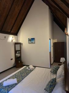 a bedroom with two large beds in a room at Sansun Villa in Harumalgoda West