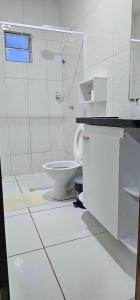 a white bathroom with a toilet and a shower at Ap Harmonia Bg in Barra Grande +24 photos