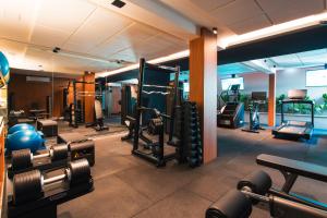 a gym with lots of equipment in a room at Livramento Palace Hotel in Vitória da Conquista
