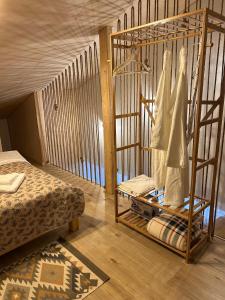 a room with a cage with a bed in it at Tiny Marae in Straja