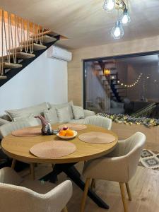 a living room with a table and a couch at Tiny Marae in Straja