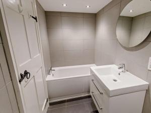 a white bathroom with a tub and a sink at 3 Bed in Baslow oc-pk917 in Baslow +17 photos