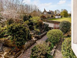 a garden with bushes and trees and a house at 3 Bed in Baslow oc-pk917 in Baslow