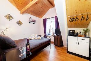 a bedroom with a bed with a bottle of wine at Café des Voyageurs Noës in Chalais +5 photos