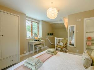 a bedroom with a bed with a desk and a mirror at 1 Bed in Wareham oc-88099 in Wool +13 photos