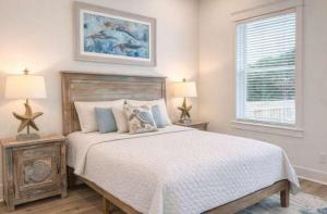 a bedroom with a large bed with two tables and a window at New- Prime Location - Ground Floor Bedroom - Pool in Eastpoint