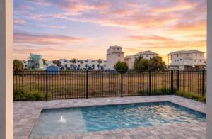 a swimming pool in front of a fence at New- Prime Location - Ground Floor Bedroom - Pool in Eastpoint +47 photos