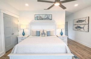 a bedroom with a white bed with two blue vases at New- Prime Location - Ground Floor Bedroom - Pool in Eastpoint