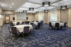 a conference room with tables and chairs and a whiteboard at Courtyard by Marriott Sacramento Midtown in Sacramento +56 photos