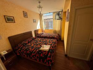 a hotel room with a bed and a window at Hotel Savoy in La Paz +10 photos