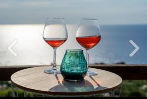two wine glasses sitting on top of a table at Villa Sunny Side - Panoramic View in Costa Paradiso
