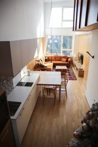 a kitchen and living room with a table and a couch at A63 Premium apartment located in hotel Vucko-private host in Jahorina