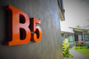 an orange number on the side of a house at Family House Zen Boutique Resort in Pai