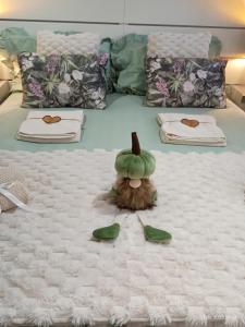 a bedroom with a bed with a green hat on it at Fienile Paradiso Home Tuscany in Campi Bisenzio
