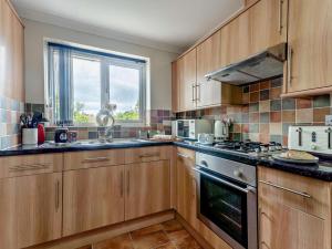 a kitchen with wooden cabinets and a stove top oven at 2 Bed in Freshwater oc-94561 in Freshwater