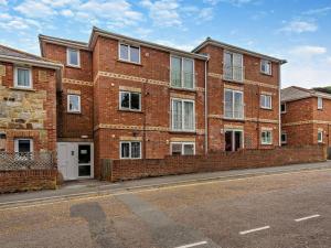 a brick building on the side of a street at 2 Bed in Freshwater oc-94561 in Freshwater